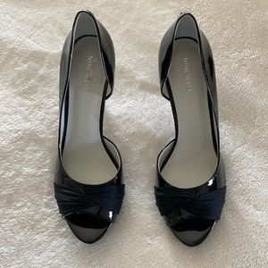 Black patent peep toe pumps.